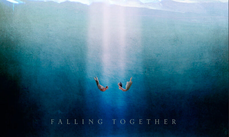 A cover showing two human figures drifting downward together in a vast, blue, ocean-like void. Light beams descend from a cloudy surface above, while the curved edge of Earth glows faintly below.