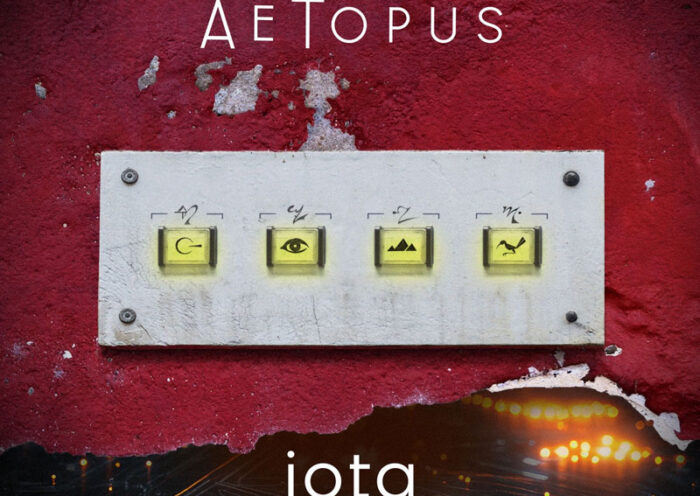 The album cover for iota by AeTopus features a textured red wall with a weathered white panel mounted on it. The panel contains four illuminated buttons, each adorned with a cryptic symbol— a looped arrow, an eye, a mountain range, and a bird in flight. Above, the artist's name, AeTopus, is displayed in a sleek, modern font, while the album title, iota, is placed below against a dark background with glowing city lights and streaks of motion.