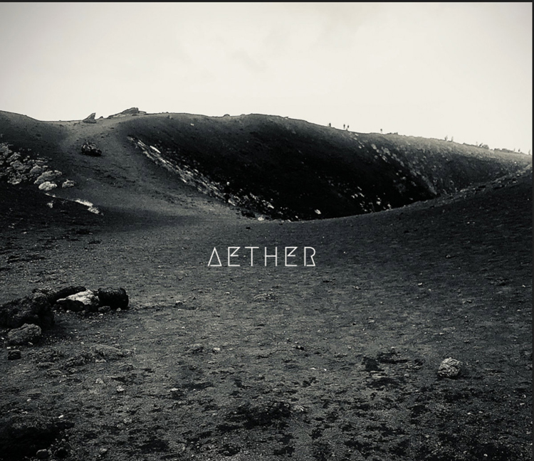 Aether - Aether cover artwork. A black and white picture of a mountain volcanic landscape.