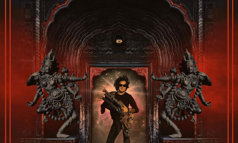 The album cover for Liquid Reality by Anupam Shobhakar features a central figure, presumably Shobhakar, who stands in a cosmic portal, clad in black and holding an intricately designed electric instrument. Framing the scene is an ornate, temple-like archway with intricate carvings, steeped in deep reds and blacks, evoking a sense of ancient grandeur. Two multi-armed goddess-like statues flank the entrance. Above, a single eye watches from within the arch.