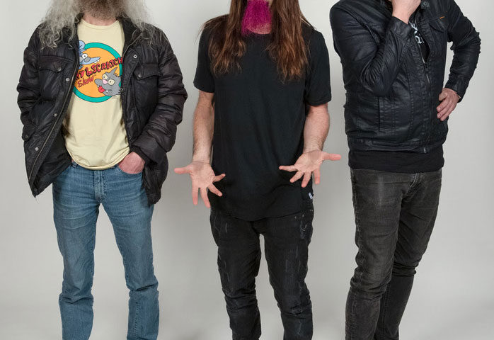 The Aristocrats band photo posing for camera.