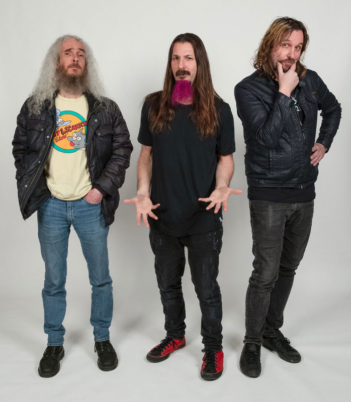 The Aristocrats band photo posing for camera.