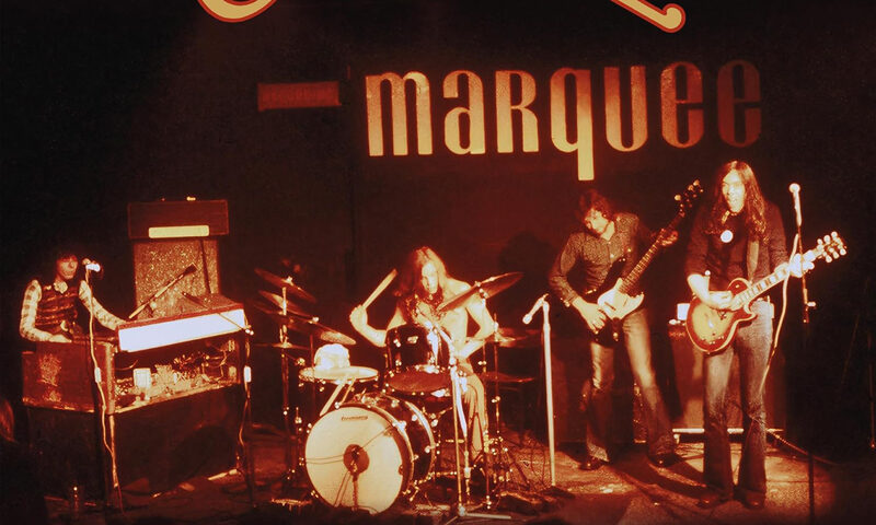 Camel Earthrise Live at the Marquee 1974 cover artwork. A photo of the band playing live.