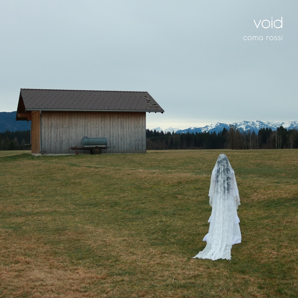 Coma Rossi – "Void cover artwork. a photo of the bavk of a woman in a wedding gown looking towards a barn and distant snow capped mountains.
