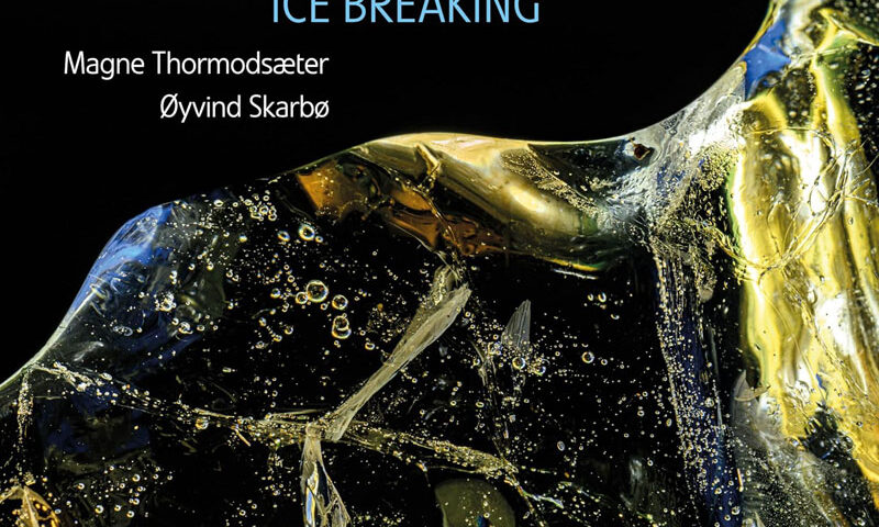 The album cover for Ice Breaking by the Dag Arnesen Trio features a close-up of a fractured ice formation, illuminated by golden and blue reflections against a deep black background. The typography is clean and modern, with "Ice Breaking" in a cool blue hue. The names of bassist Magne Thormodsæter and drummer Øyvind Skarbø appear beneath the title, while the Losen Records logo sits subtly in the corner.