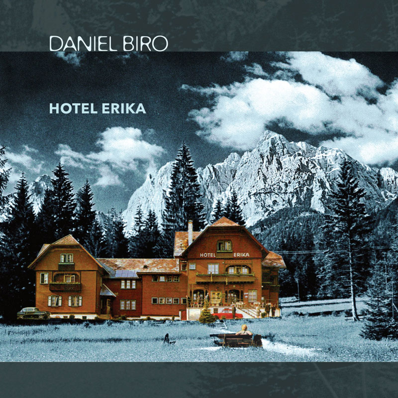 Daniel Biro - Hotel Erika cover artwork. A photo of Hotel Erika with trees and the Alps mountains in the background..