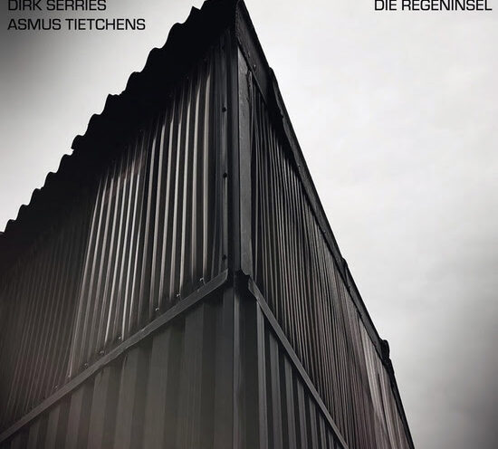 Dirk Serries and Asmus Tietchens - Die Regeninsel cover artwork. The cover of Die Regeninsel features an upward-looking photograph of a corrugated metal structure shot from a corner angle. The artists' names appear in the upper left corner, while the album title sits opposite in the upper right.