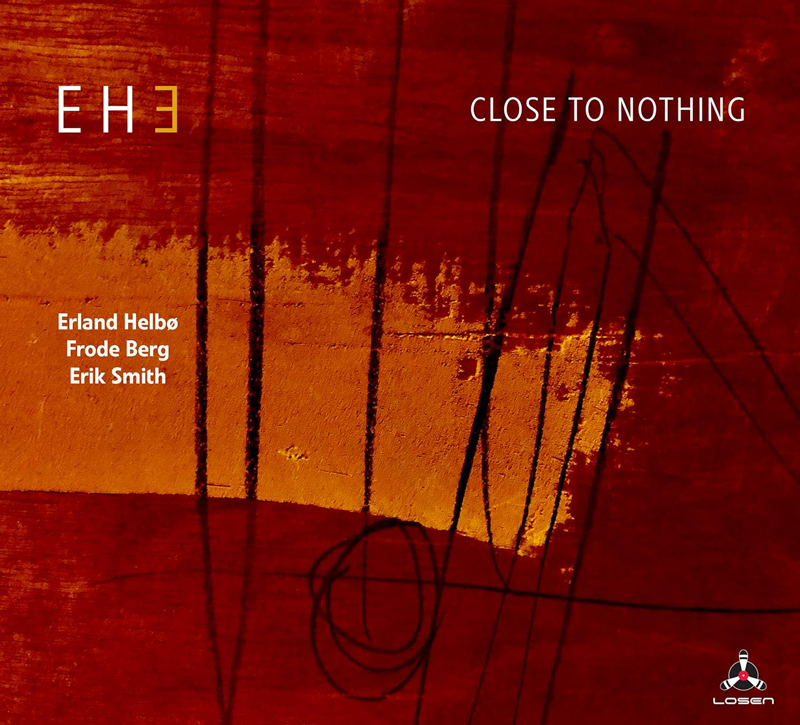 The album cover for Close to Nothing by EH3 presents warm shades of red and orange. Dark linear strokes intersect the composition. The band name EH3 appears at the top left, with the album title Close to Nothing placed to the right. Below, the musicians’ names—Erland Helbø, Frode Berg, and Erik Smith—are listed in white text. The Losen Records logo sits in the bottom right corner.