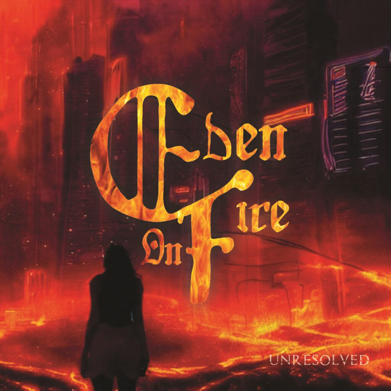 The album cover shows a fiery, apocalyptic cityscape engulfed in red and orange flames. A silhouetted figure stands in the foreground, facing the inferno. Bold, flame-styled gothic lettering spells out “Eden on Fire”, while the word “Unresolved” appears subtly in the bottom right corner.