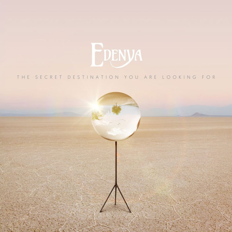 The album cover for Edenya – The Secret Destination You Are Looking For features a desert landscape under a soft pink sky. At the center stands a reflective orb on a tripod, capturing an inverted image of a scene with palm trees and birds. The band's name appears above in stylized white lettering, while the album title is set below in minimalist uppercase text.