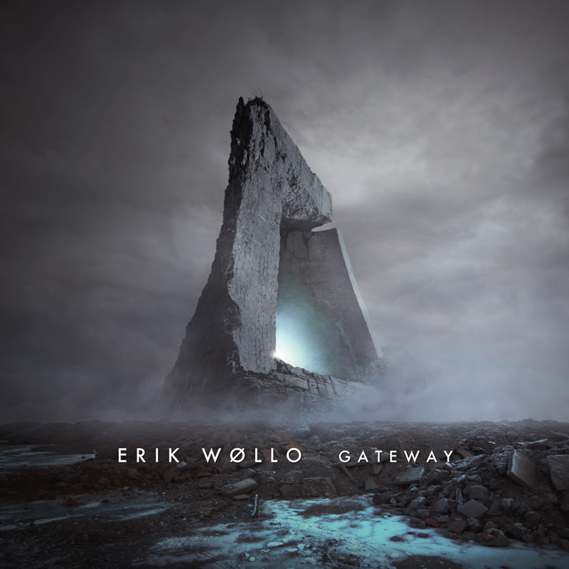 The album cover for Gateway by Erik Wøllo features a towering, monolithic stone structure shaped like an abstract arch or portal, set against a desolate, misty landscape. A soft, ethereal blue light glows from within the gateway.