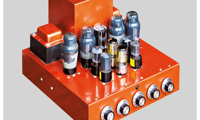 The album cover for Frost*'s Western Atmosphere features a striking image of a bright orange, retro-style tube amplifier against a neutral gray background. The minimalist layout highlights the amplifier's intricate design, with its glowing vacuum tubes and tactile knobs. The band's name and album title appear in clean, modern typography at the bottom.