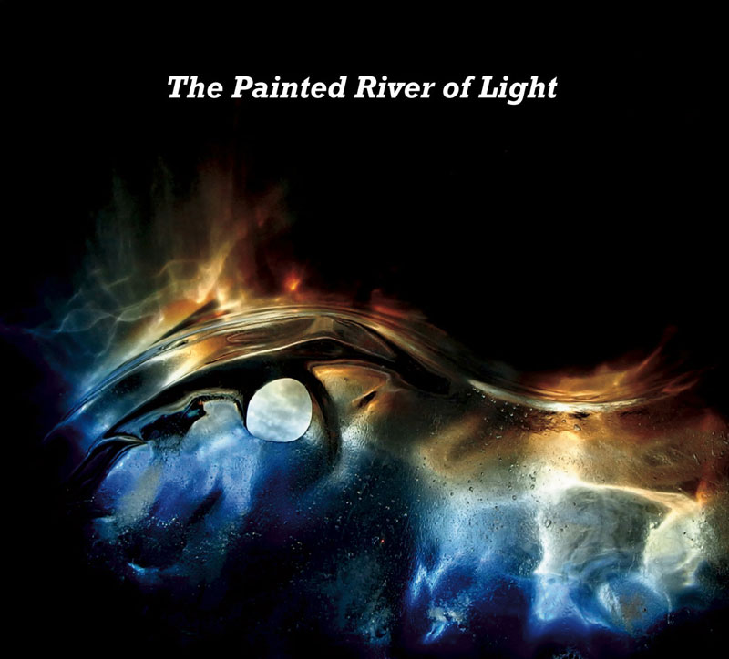 The album cover for The Painted River of Light features an abstract, metallic surface resembling a flowing, reflective liquid. The colors blend deep blues, golds, and fiery oranges. A bright, glowing orb sits within the composition.