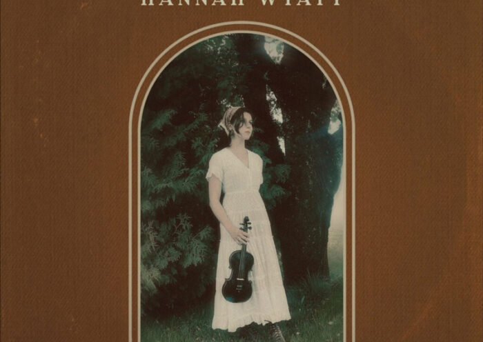 Hannah Wyatt – "Sunday Cowboy cover artwork. A photo of the artist outdoors holding a fiddle.