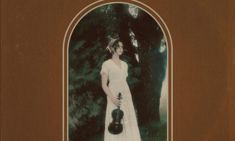 Hannah Wyatt – "Sunday Cowboy cover artwork. A photo of the artist outdoors holding a fiddle.