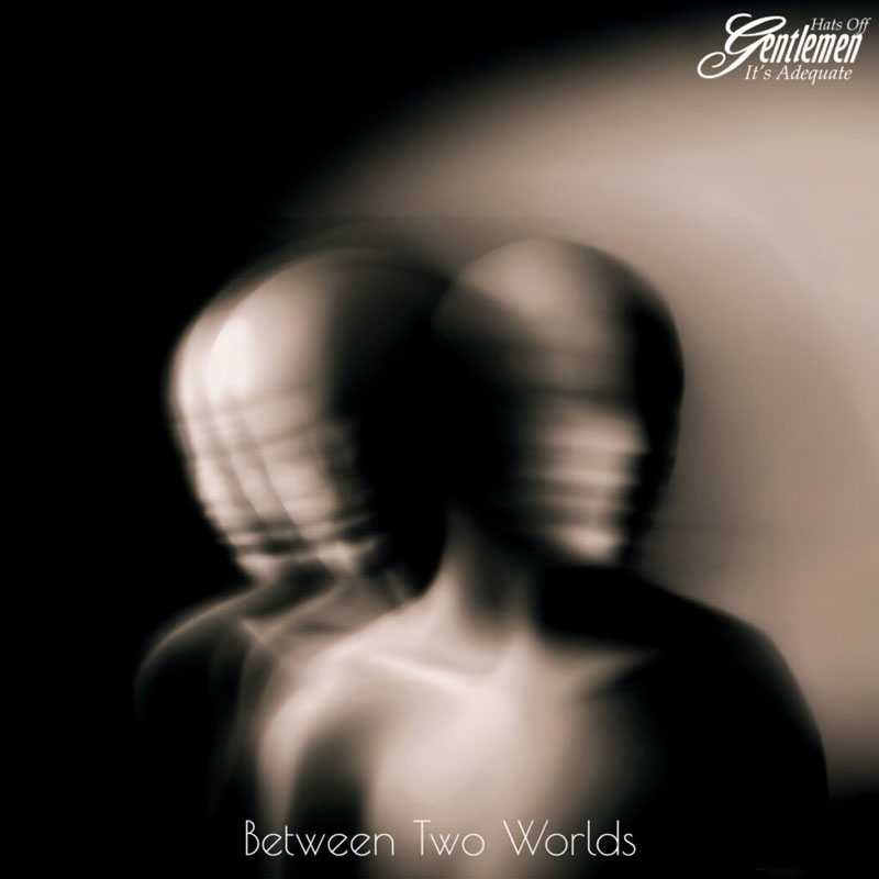 The album cover for Between Two Worlds by Hats Off Gentlemen It's Adequate features a surreal, blurred double-exposure effect of a faceless humanoid figure.