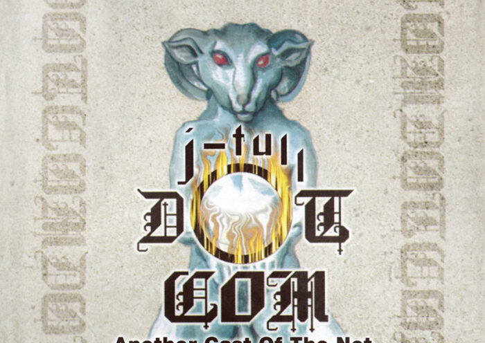 Jethro Tull J-Tull Dot Com Another Cast Of The Net cover artwork. The cover features a pale blue, ram-like humanoid figure with glowing red eyes, seated and holding a luminous white orb surrounded by golden flames.