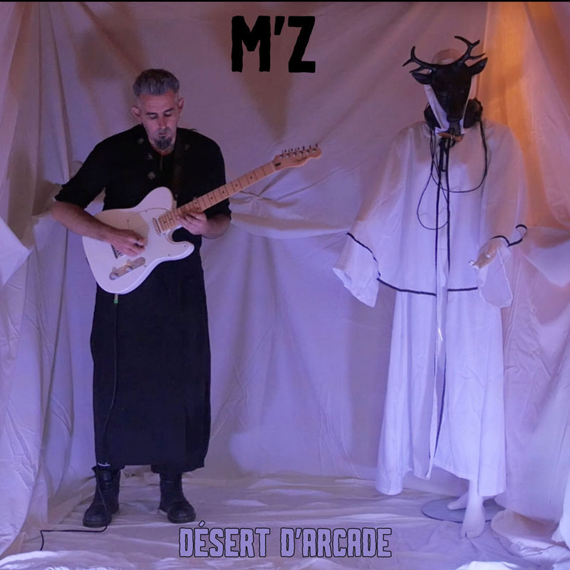 The cover of the single by M'Z, titled "Désert d'Arcade," features a minimalist and surreal aesthetic. On the left, a man in black, holding a white electric guitar, stands against a backdrop of draped white fabric. To the right, a mannequin-like figure dressed in flowing white robes with black accents wears a mask resembling a deer head.