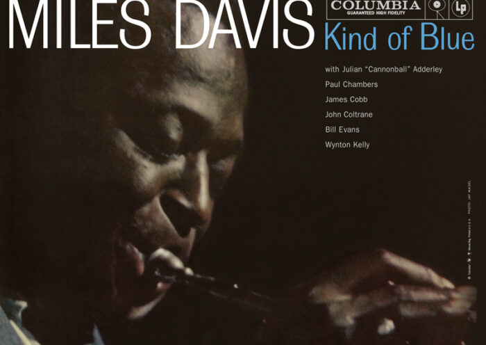 Miles Davis’ Kind Of Blue cover artwork. A photo of miles playing trumpet.