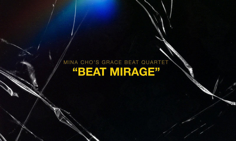 The album cover for Beat Mirage by Mina Cho’s Grace Beat Quartet is a minimalist design. It features a dark, almost black background with jagged, cracked glass-like textures running across the image. A spectral burst of rainbow light emerges in the upper left portion. The album title, Beat Mirage, appears in bold yellow uppercase letters.