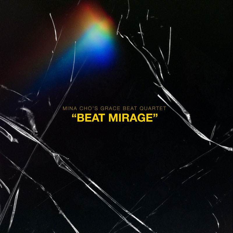 The album cover for Beat Mirage by Mina Cho’s Grace Beat Quartet is a minimalist design. It features a dark, almost black background with jagged, cracked glass-like textures running across the image. A spectral burst of rainbow light emerges in the upper left portion. The album title, Beat Mirage, appears in bold yellow uppercase letters.