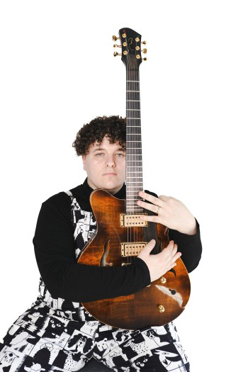 Nicholas Mycio holding his guitar