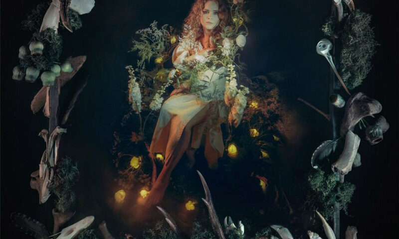 Olga Dikajee Karpova – The Frame cover artwork. Olga surrounded by shamanic symbols, including animal skulls.