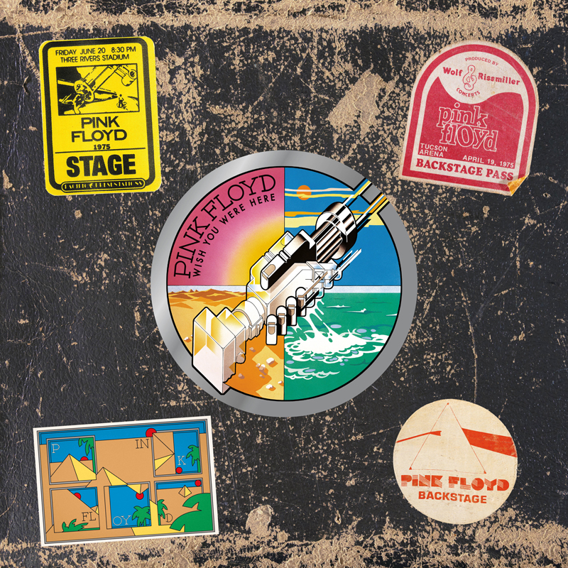 The 50th anniversary 3LP edition of Wish You Were Here features a collage-style cover. At its center is the classic artwork of two robotic hands shaking, split into four vivid quadrants: desert, ocean, sky, and sunset. Surrounding this emblem are colorful vintage tour stickers and backstage passes from Pink Floyd’s 1975 shows, all set against a black background resembling a worn road case.