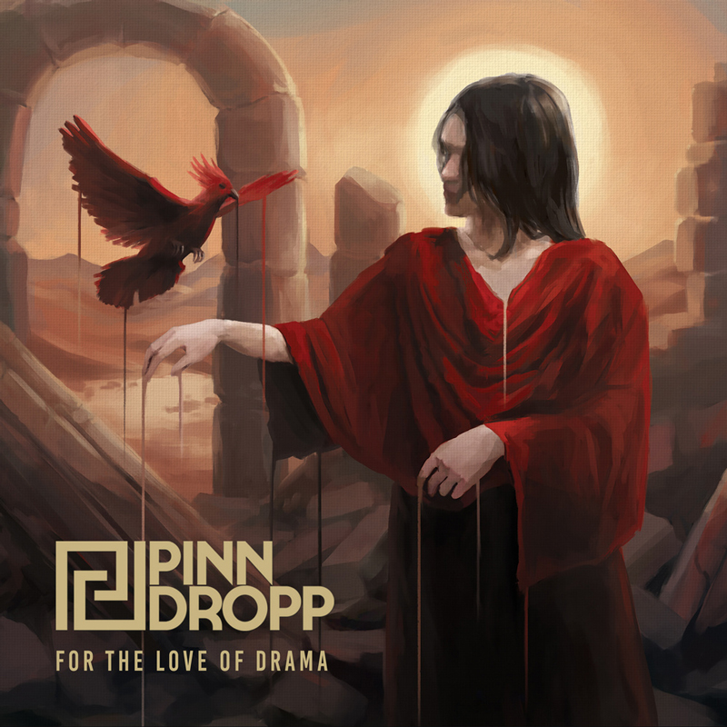 The album cover for For The Love of Drama by Pinn Dropp depicts a scene set among ancient ruins. A person draped in a flowing red robe extends an arm toward a red bird that appears to be tethered or bleeding, with streaks of red connecting them. The background glows with warm light from a low sun, framed by broken stone arches and barren desert terrain. The band’s logo and title appear in gold lettering at the lower left.