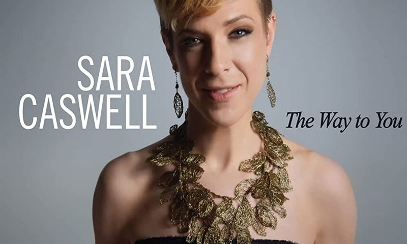 Sara Caswell — The Way To You cover artwork. A photo of Caswell holding a violin to her chest.