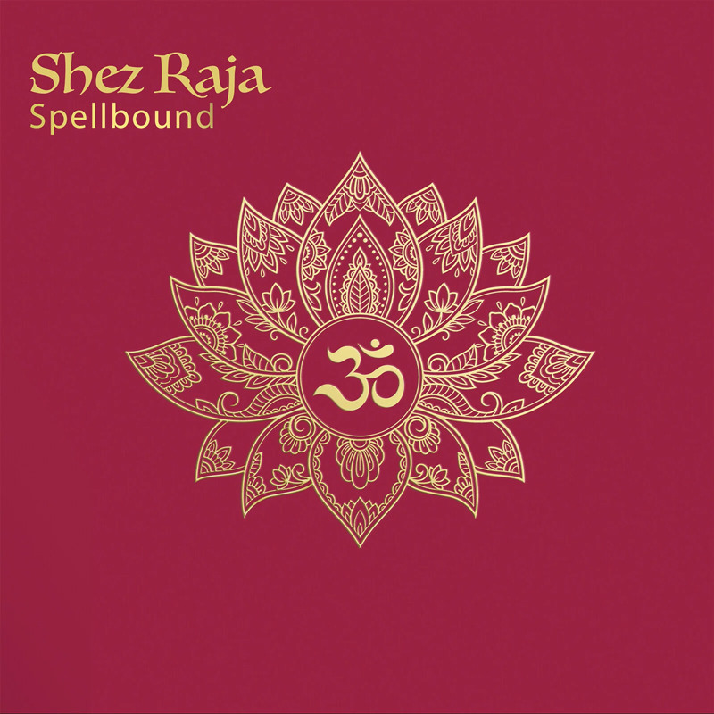 The album cover for Spellbound by Shez Raja features a deep maroon background with a gold, intricately designed lotus mandala at the center. Within the mandala’s core is the “Om” symbol, also in gold. The artist's name and album title appear in the top left corner in gold serif typography.