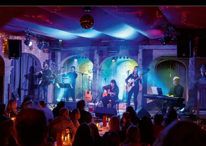 Steve Hackett Live Magic At Trading Boundaries cover artwork. A color photo of Hackett and his band playing live.