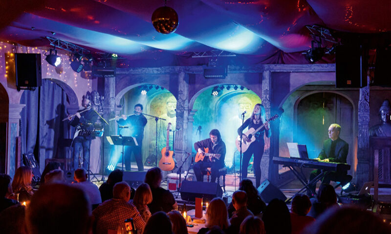 Steve Hackett Live Magic At Trading Boundaries cover artwork. A color photo of Hackett and his band playing live.