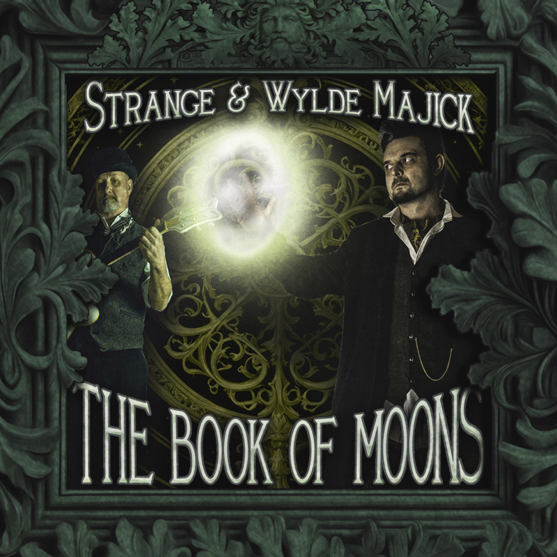The cover of Strange & Wylde Majick by The Book of Moons features two men in vintage attire, one holding a guitar and the other conjuring a glowing orb of light. Ornate green foliage frames the scene, with an intricate golden circular design in the background. The title appears in bold, gothic-style lettering beneath the artists’ names.