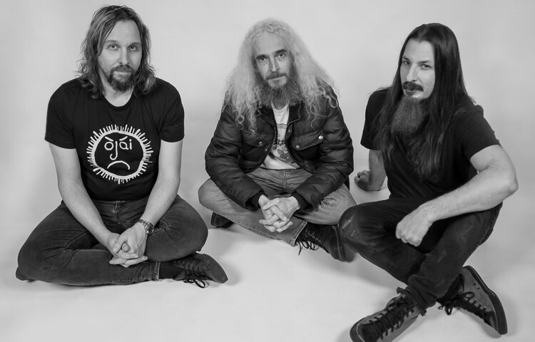 The Aristocrats in 2023 - Photo by Arthur Rosato. Black and white photo. The three band members stting.