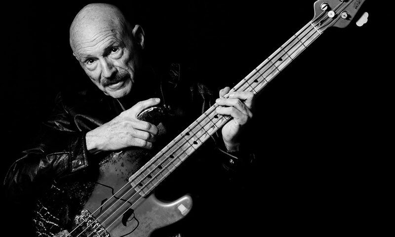 Tony Levin - Bringing It Down to the Bass cover artwork. A black and white photo of Levin holding an electric bass.