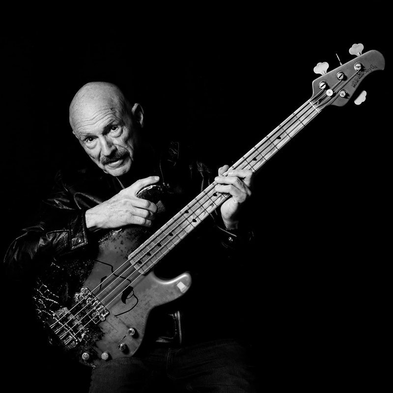 Tony Levin - Bringing It Down to the Bass cover artwork. A black and white photo of Levin holding an electric bass.