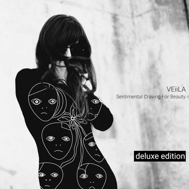 VEiiLA – "Sentimental Craving for Beauty - Deluxe Edition cover artwork. A photo of a woman with sunglasses. Her black dress has faces drawn on it.