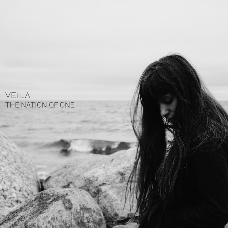 VEiiLA – "The Nation of One" cover artwork. A photo of the artist by the beach.