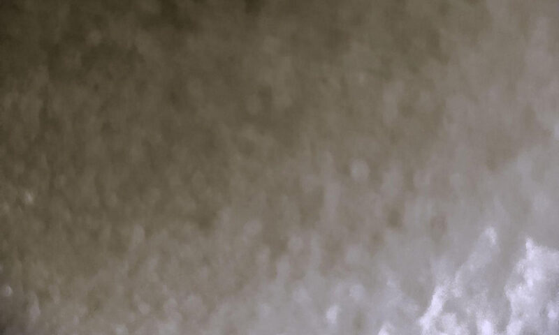 The cover of Formless by Volker Lankow features a blurred surface in muted gray tones, creating a grainy effect. At the bottom, a taupe strip carries the artist’s name and album title in simple white lowercase text.