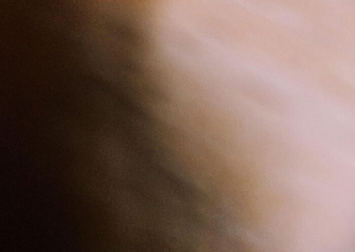 The album cover for Slow and Looped by Volker Lankow features a soft blur in warm brown and beige tones. The artist's name and album title appear in lowercase at the bottom in a serif font against a dark brown band.