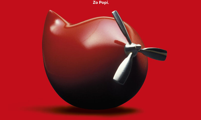 Zo Popi - Do It Right Now cover artwork. A round object with an airplane propeller, with a red background.